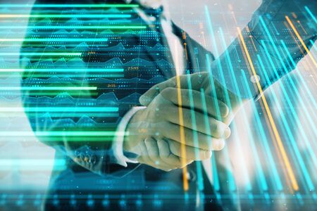 Double exposure of financial graph on cityscape background with two businessman handshake. Concept of stock market dealの写真素材