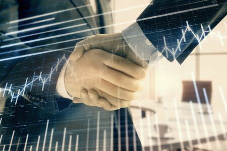 Multi exposure of financial graph on office background with two businessmen handshake. Concept of success in businessの写真素材