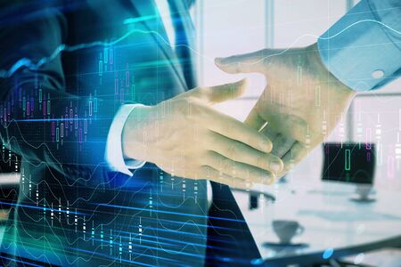 Multi exposure of financial graph on office background with two businessmen handshake. Concept of success in businessの写真素材