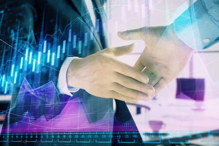 Multi exposure of financial graph on office background with two businessmen handshake. Concept of success in businessの写真素材