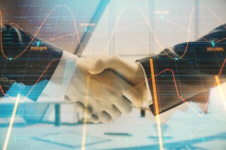 Multi exposure of financial graph on office background with two businessmen handshake. Concept of success in businessの写真素材