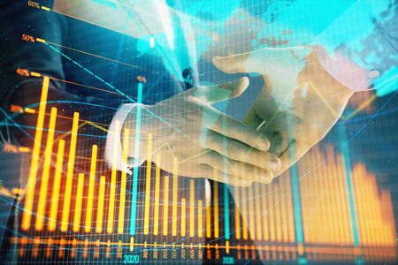 Multi exposure of forex graph and world map on abstract background with two businessmen handshake. Concept of success on international marketsの写真素材