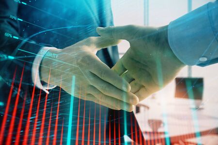 Multi exposure of financial graph on office background with two businessmen handshake. Concept of success in businessの写真素材