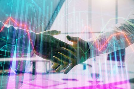Multi exposure of financial graph on office background with two businessmen handshake. Concept of success in businessの写真素材