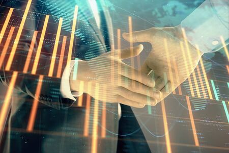 Multi exposure of forex graph and world map on abstract background with two businessmen handshake. Concept of success on international marketsの写真素材