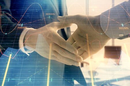 Multi exposure of financial graph on office background with two businessmen handshake. Concept of success in businessの写真素材