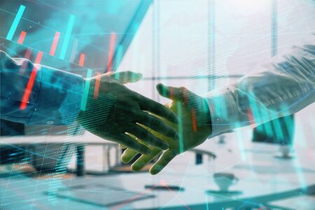 Multi exposure of financial chart and map on office background with two businessmen handshake. Concept of success in businessの写真素材