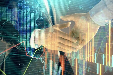 Multi exposure of forex graph and world map on abstract background with two businessmen handshake. Concept of success on international marketsの写真素材