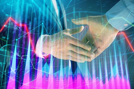 Multi exposure of forex graph on abstract background with two businessmen handshake. Concept of success on stock marketの写真素材
