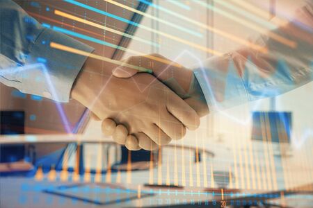 Multi exposure of financial graph on office background with two businessmen handshake. Concept of success in businessの写真素材