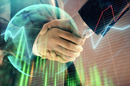 Multi exposure of forex graph and world map on abstract background with two businessmen handshake. Concept of success on international marketsの写真素材