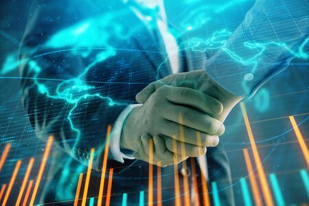 Multi exposure of forex graph and world map on abstract background with two businessmen handshake. Concept of success on international marketsの写真素材