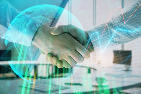 Multi exposure of financial chart and map on office background with two businessmen handshake. Concept of success in businessの写真素材