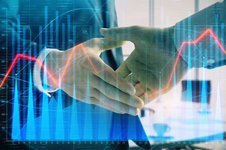 Multi exposure of financial graph on office background with two businessmen handshake. Concept of success in businessの写真素材