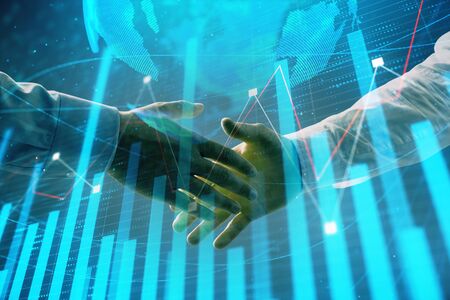 Multi exposure of forex graph and world map on abstract background with two businessmen handshake. Concept of success on international marketsの写真素材