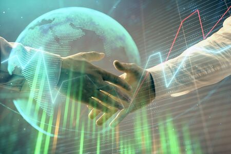 Multi exposure of forex graph and world map on abstract background with two businessmen handshake. Concept of success on international marketsの写真素材