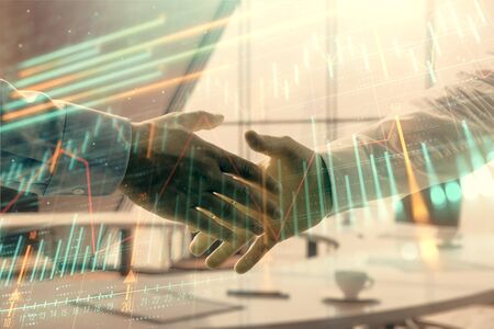Multi exposure of financial graph on office background with two businessmen handshake. Concept of success in businessの写真素材