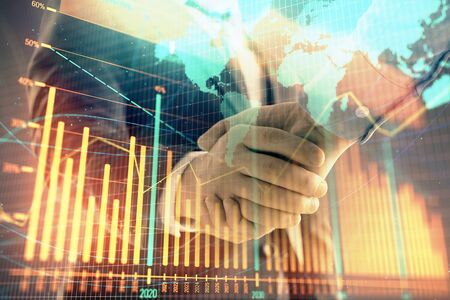 Multi exposure of forex graph and world map on abstract background with two businessmen handshake. Concept of success on international marketsの写真素材