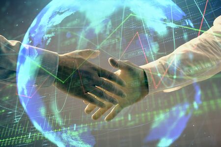 Multi exposure of forex graph and world map on abstract background with two businessmen handshake. Concept of success on international marketsの写真素材