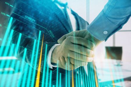 Multi exposure of financial graph on office background with two businessmen handshake. Concept of success in businessの写真素材