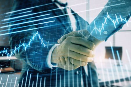 Multi exposure of financial graph on office background with two businessmen handshake. Concept of success in businessの写真素材