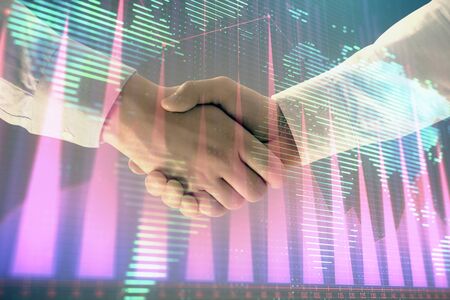 Multi exposure of forex graph and world map on abstract background with two businessmen handshake. Concept of success on international marketsの写真素材