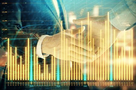 Double exposure of financial chart on cityscape background with two businessmen handshake. Concept of financial analysis and investment opportunitiesの写真素材