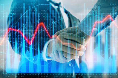 Double exposure of financial graph on cityscape background with two businessman handshake. Concept of stock market dealの写真素材
