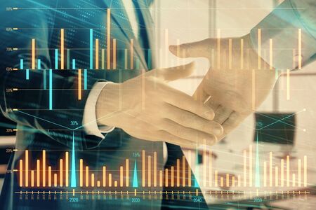 Multi exposure of financial graph on office background with two businessmen handshake. Concept of success in businessの写真素材