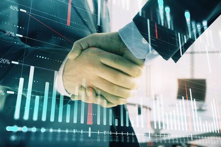 Multi exposure of financial graph on office background with two businessmen handshake. Concept of success in businessの写真素材