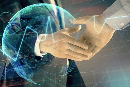 Multi exposure of forex graph and world map on abstract background with two businessmen handshake. Concept of success on international marketsの写真素材