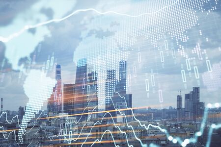 Double exposure of financial graph and world map on city view background. Concept of financial market research and analysisの写真素材