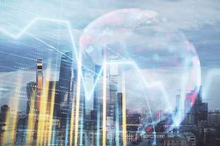 Double exposure of financial graph and world map on city view background. Concept of financial market research and analysisの写真素材