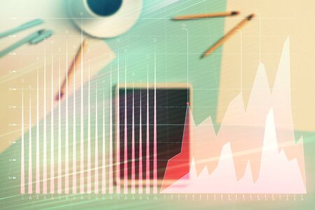 Double exposure of forex graph on digital tablet laying on table background. Concept of market analysisの写真素材