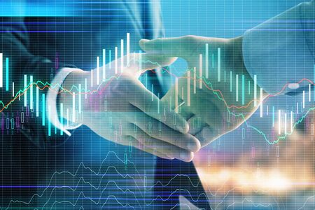 Double exposure of financial chart on cityscape background with two businessmen handshake. Concept of financial analysis and investment opportunitiesの写真素材
