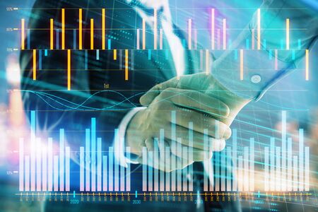 Double exposure of financial chart on cityscape background with two businessmen handshake. Concept of financial analysis and investment opportunitiesの写真素材
