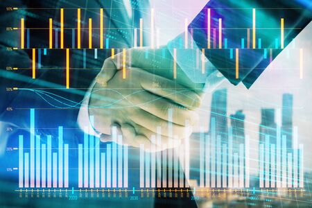 Double exposure of financial graph on cityscape background with two businessman handshake. Concept of stock market dealの写真素材