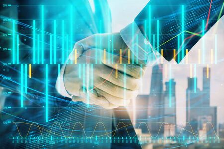 Double exposure of financial graph on cityscape background with two businessman handshake. Concept of stock market dealの写真素材