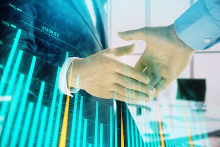 Multi exposure of financial graph on office background with two businessmen handshake. Concept of success in businessの写真素材