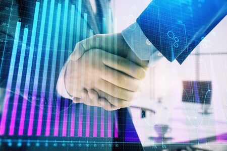 Multi exposure of financial graph on office background with two businessmen handshake. Concept of success in businessの写真素材