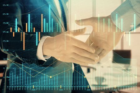 Multi exposure of financial graph on office background with two businessmen handshake. Concept of success in businessの写真素材
