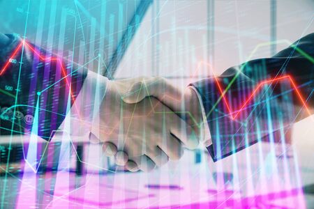 Multi exposure of financial graph on office background with two businessmen handshake. Concept of success in businessの写真素材