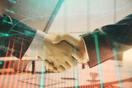 Multi exposure of financial graph on office background with two businessmen handshake. Concept of success in businessの写真素材