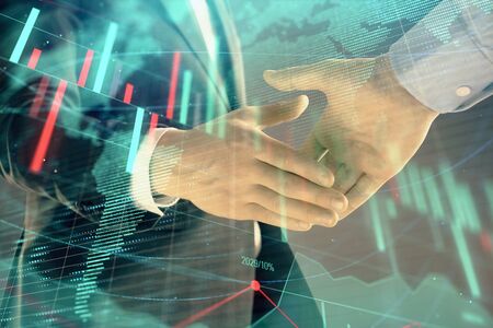 Multi exposure of forex graph and world map on abstract background with two businessmen handshake. Concept of success on international marketsの写真素材