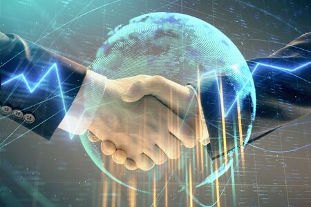Multi exposure of forex graph and world map on abstract background with two businessmen handshake. Concept of success on international marketsの写真素材