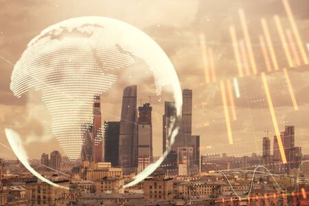 Double exposure of financial graph and world map on city veiw background. Concept of financial market research and analysisの写真素材