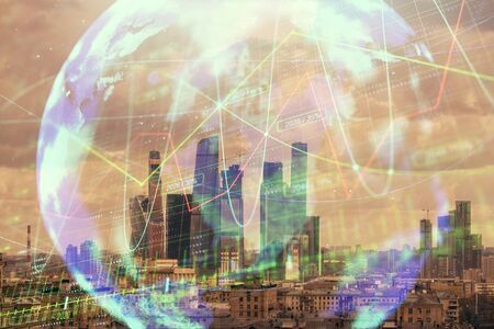 Double exposure of financial graph and world map on city veiw background. Concept of financial market research and analysisの写真素材