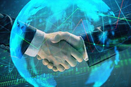 Multi exposure of forex graph and world map on abstract background with two businessmen handshake. Concept of success on international marketsの写真素材
