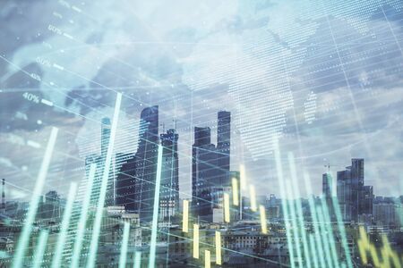 Double exposure of financial graph and world map on city veiw background. Concept of financial market research and analysisの写真素材
