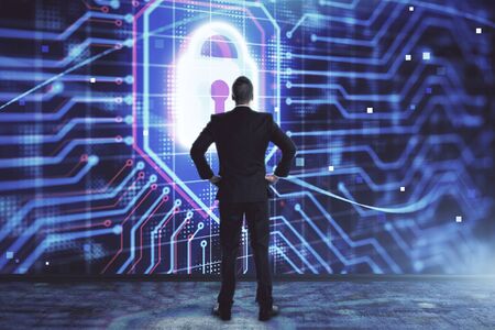 Businessman and lock icon hologram. Double exposure. Concept of data securityの写真素材